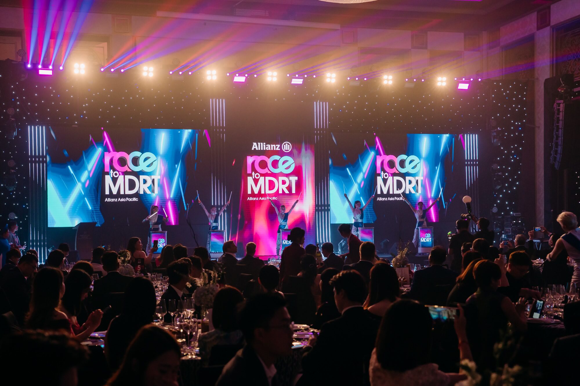 Allianz gala ballroom wrapped floor to ceiling in black star cloth, stage lit