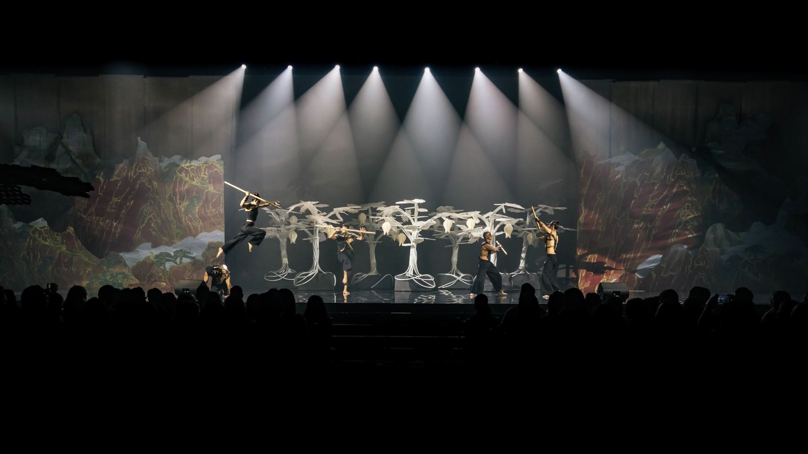White stage lighting beams over a scenic set in Vietnam